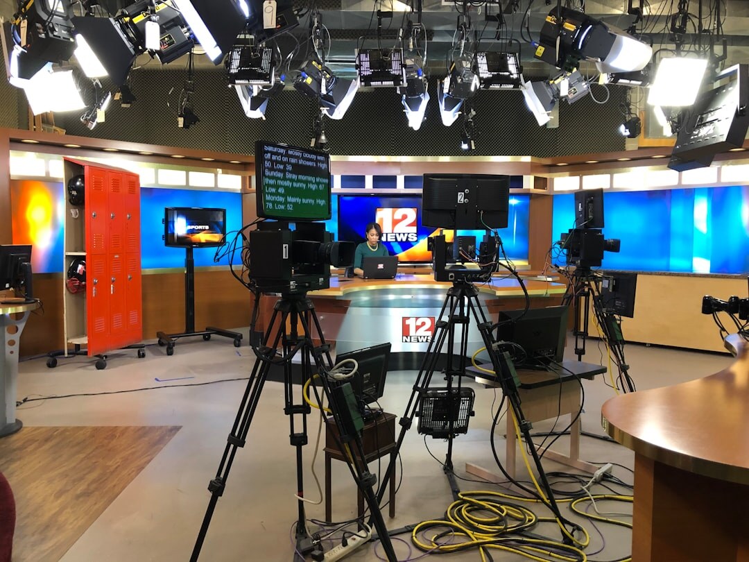 Empty television news desk with studio lights